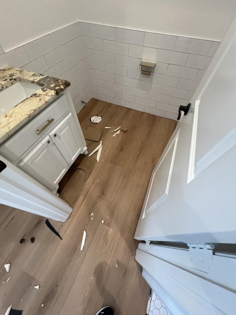Bathroom flooring and finish details from a remodeling project completed by Apex Point Services