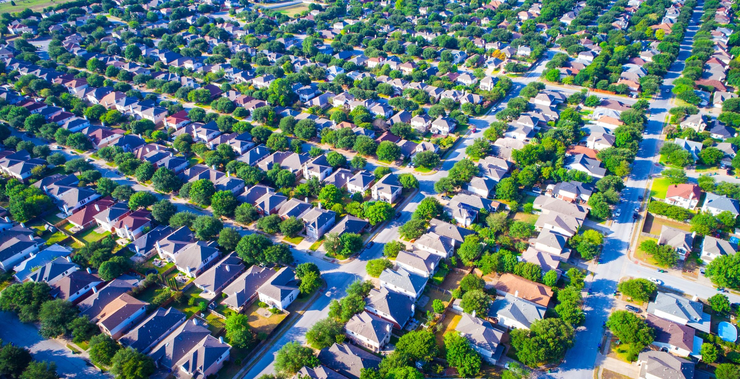 Residential roofing across a Texas neighborhood