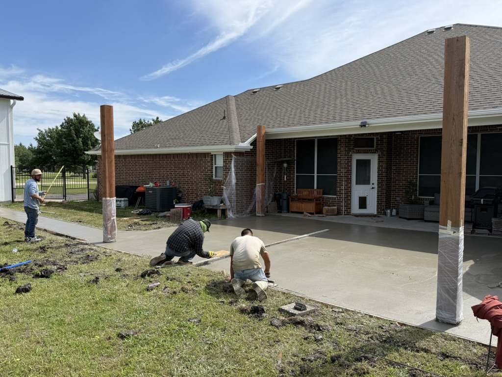 Pergola construction crew setting posts and pouring concrete in Rockwall
