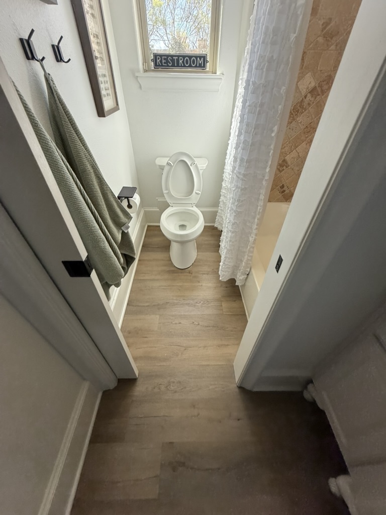 Completed LVP flooring in bathroom after pipe burst damage, Rowlett TX