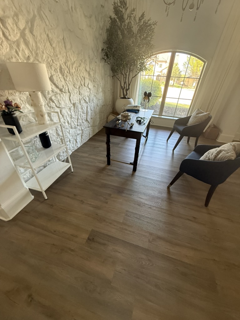 Restored sitting room with new LVP flooring and painted walls after pipe burst damage, Rowlett TX