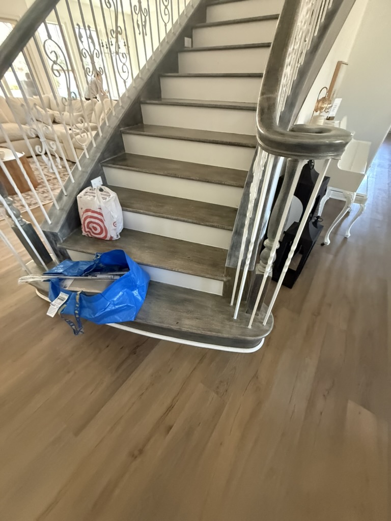 Staircase with restored treads and new flooring, Rowlett TX pipe burst restoration