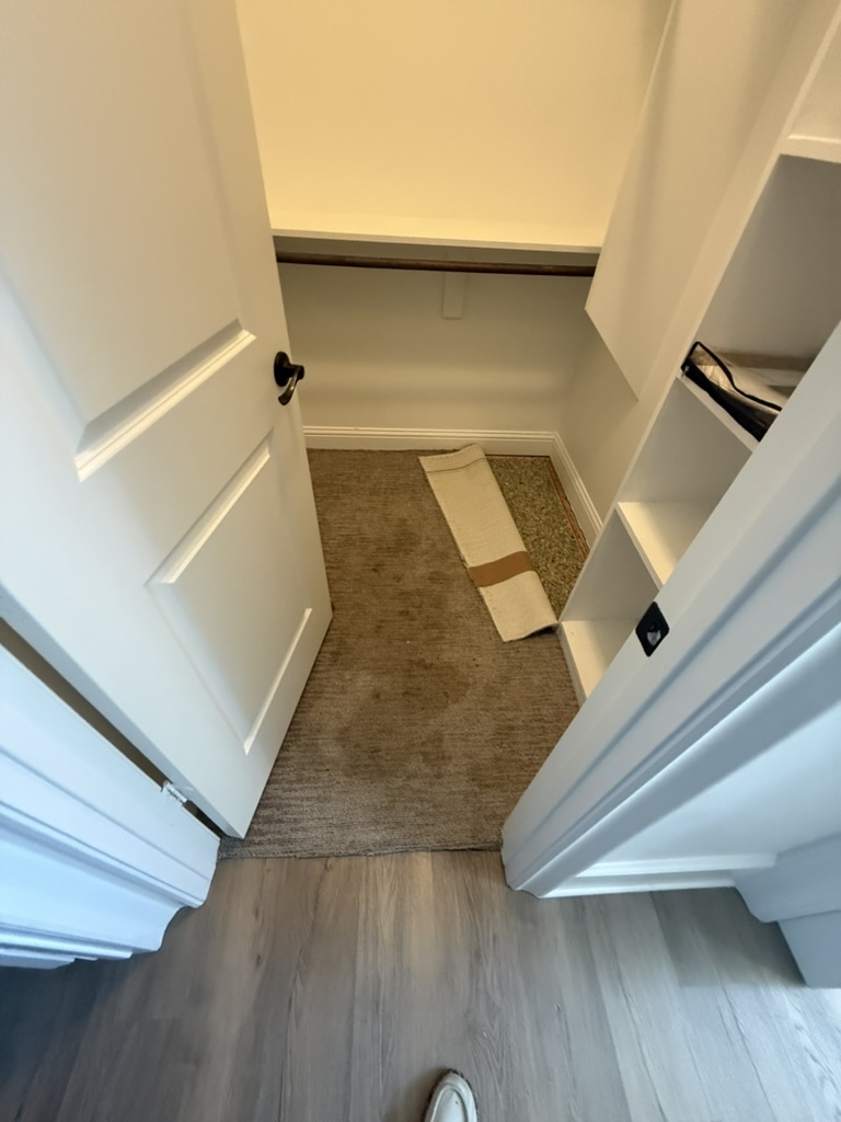 Closet with old damaged flooring removed before installation, Rowlett TX pipe burst repair